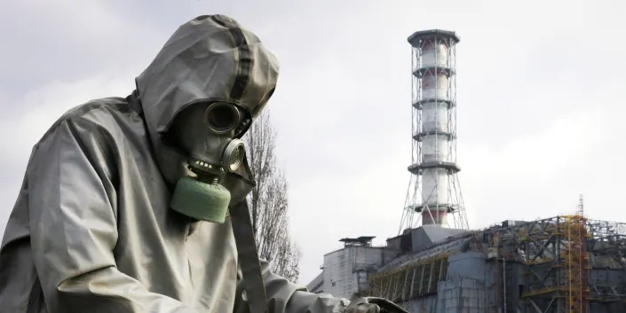 A rescue worker sets flag signalling radioactivity in front of Chernobyl nuclear power plant during a drill organized by Ukraine's Emergency Ministry 08 November 2006.