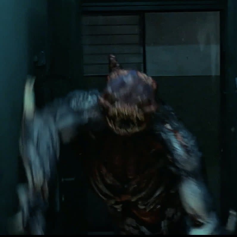 A mutant creature running through a doorway