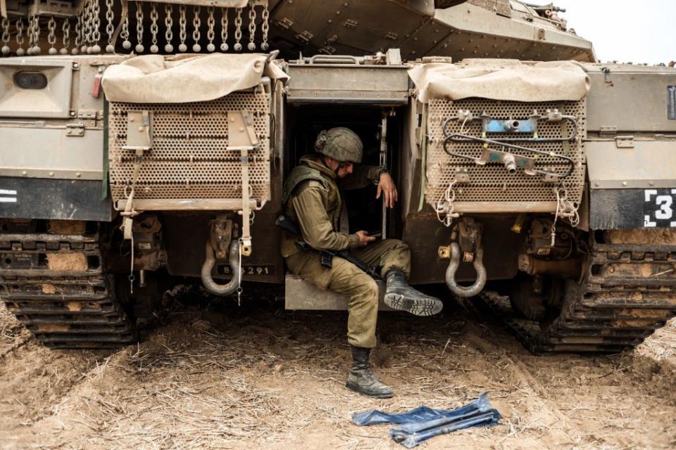 An Israeli soldier sits in side a tank at the Israel-Gaza border. Fighting between Israeli soldiers and Islamist Hamas militants continues in the border area with Gaza.