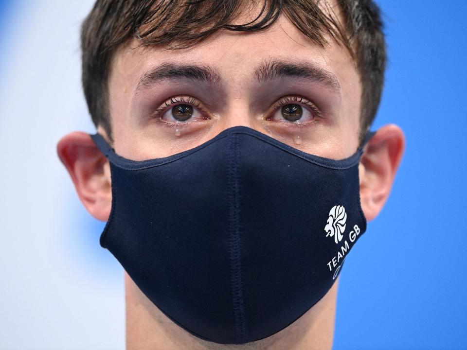 Britain's Thomas Daley and Britain's Matty Lee (unseen) as they wait to receive their medals after wining the men's synchronised 10m platform diving final event during the Tokyo 2020 Olympic Games at the Tokyo Aquatics Centre