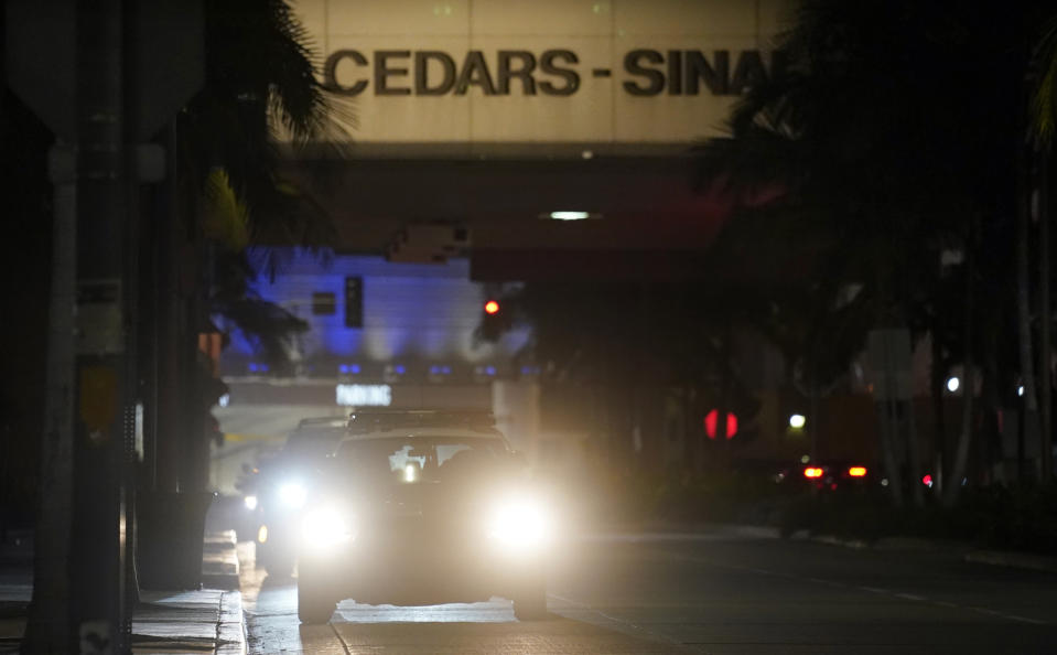 A police vehicle idles outside Cedars-Sinai Medical Center, late Tuesday, Jan. 5, 2021, in Los Angeles. Music producer and hip hop legend Dr. Dre is hospitalized in the intensive care unit at Cedars-Sinai after suffering a brain aneurysm Monday. (AP Photo/Chris Pizzello)