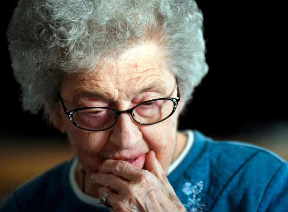 In this undated photo, Edna Schmeets, 90, reflects on being scammed out of her life savings by Jamaican criminals, at her home in Harvey, N.D. (Mike McCleary/The Bismarck Tribune via AP)