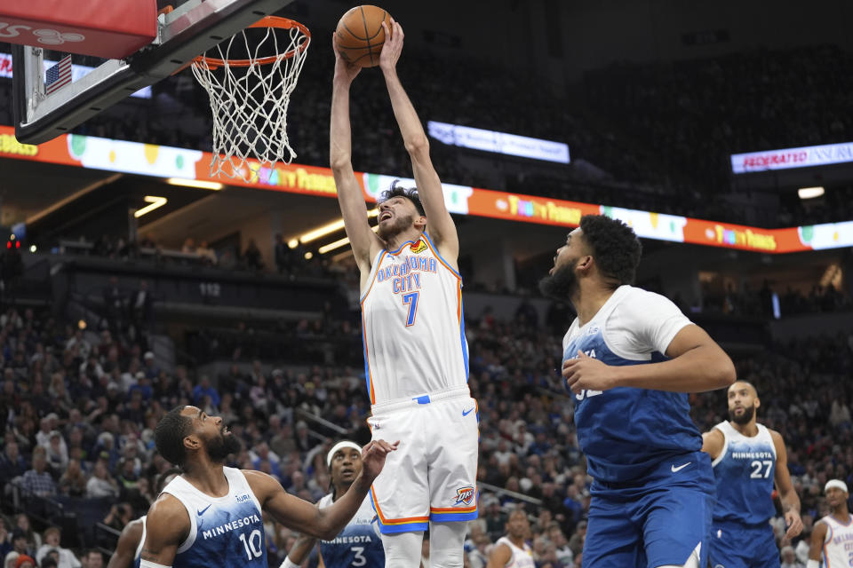 Oklahoma City Thunder forward Chet Holmgren (7) goes up to shoot as Minnesota Timberwolves guard Mike Conley (10) defends during the second half of an NBA basketball game, Saturday, Jan. 20, 2024, in Minneapolis. (AP Photo/Abbie Parr)