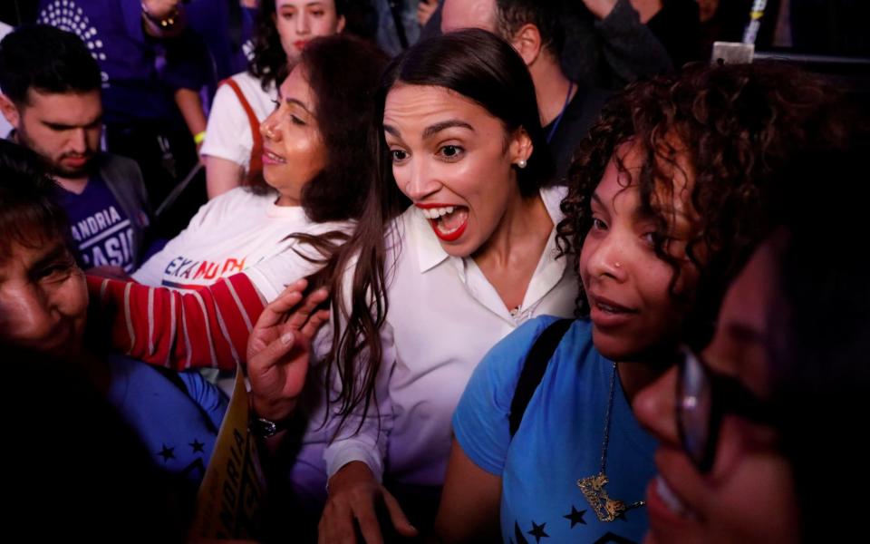 The youngest Democratic congressional candidate Alexandria Ocasio-Cortez greets supporters at her midterm election night party in New York City - REUTERS
