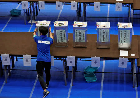 An election official places an unopened ballot box on a table after Japan's lower house election at a counting centre in Tokyo, Japan, October 22, 2017. EUTERS/Issei Kato