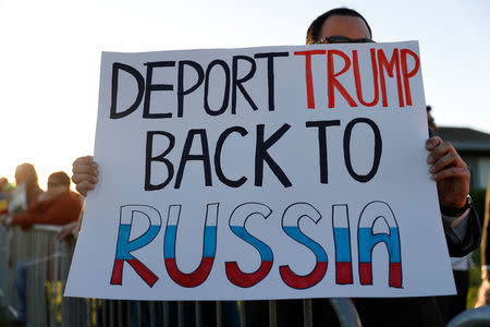 A demonstrator holds a sign before the start of a town hall meeting with Thomas Homan, acting director of U.S. Immigration and Customs Enforcement (ICE), in Sacramento, California, U.S., March 28, 2017. REUTERS/Stephen Lam