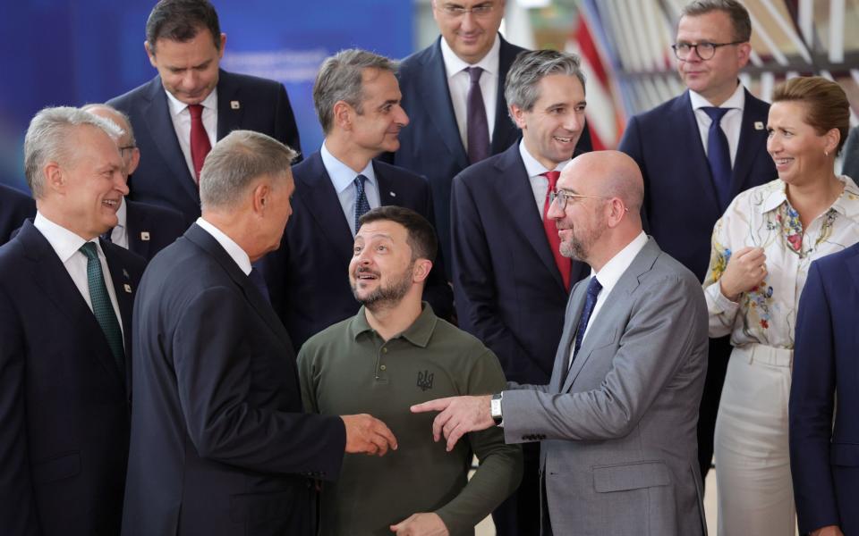 Ukraine's President Volodymyr Zelensky grins with EU leaders at the European Council in Brussels