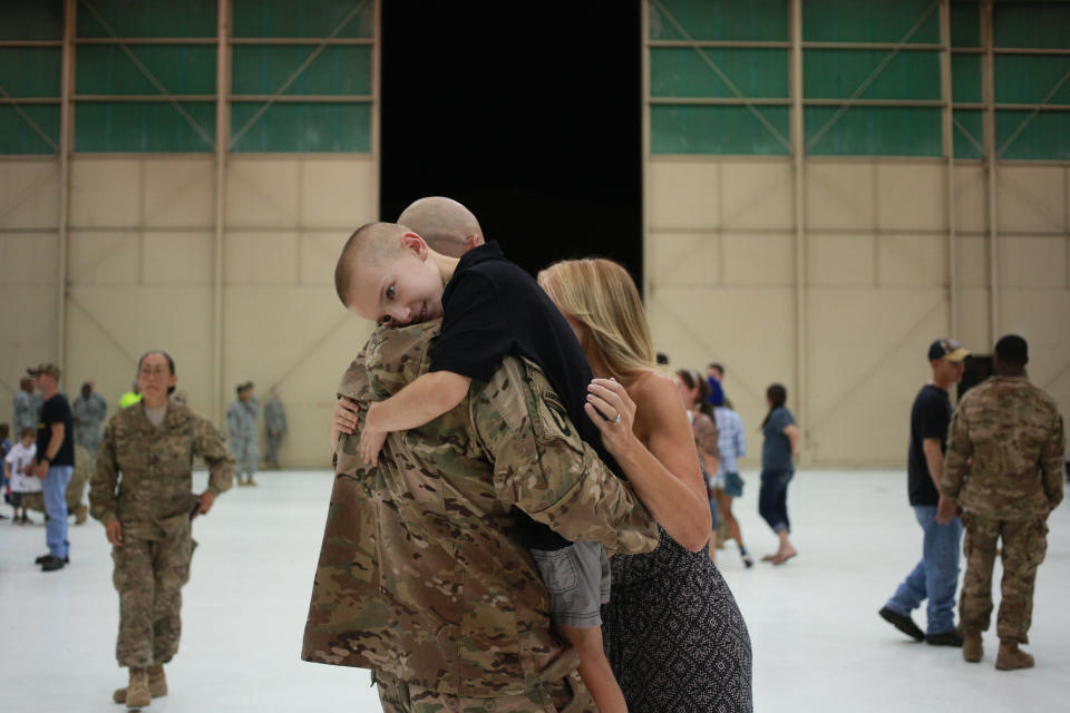 Bradyn Vest embraces his father, Sgt. 1st Class Kevin Vest of the U.S. Army's 159th Combat Aviation Brigade, 101st Airborne Division, following a homecoming ceremony at Campbell Army Airfield on Sept. 1, 2014, in Fort Campbell, Kentucky.