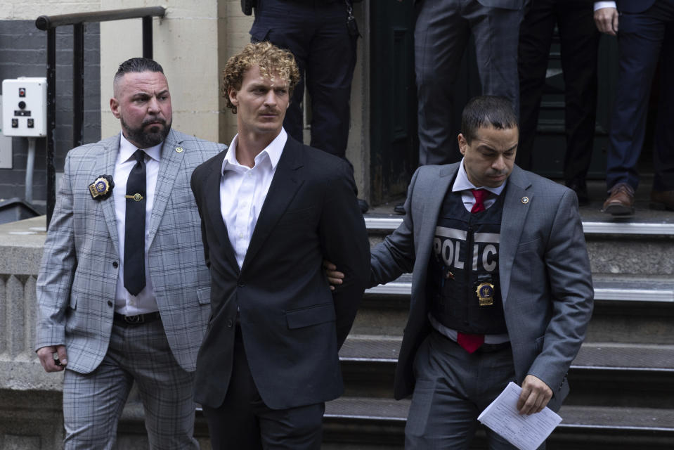 FILE - Daniel Penny, center, is walked by New York Police Department detectives out of the 5th Precinct, May 12, 2023, in New York. Penny, the man charged with manslaughter for putting an agitated New York City subway rider in a fatal chokehold, will be arraigned Wednesday in the fatal chokehold of a man who was behaving erratically on a New York City subway train. (AP Photo/Jeenah Moon, File)