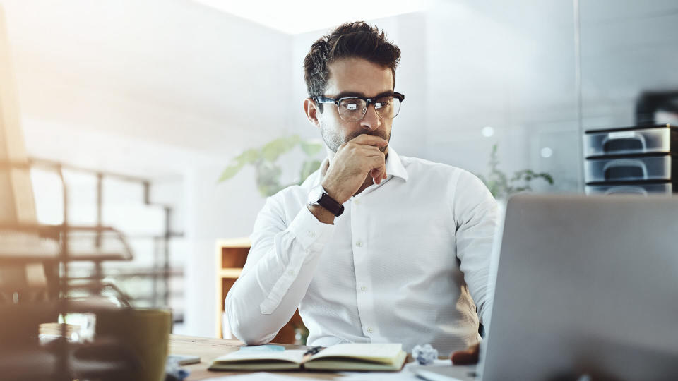 Shot of a young businessman working in an office.