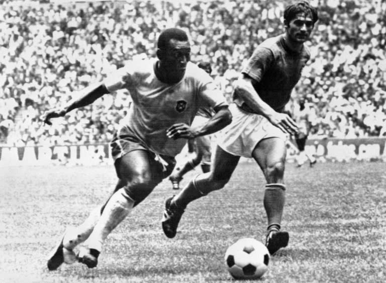 Brazilian midfielder Pele (L), today considered the greatest footballer ever by many, dribbles past Italian defender Tarcisio Burgnich during the 1970 World Cup final in Mexico City