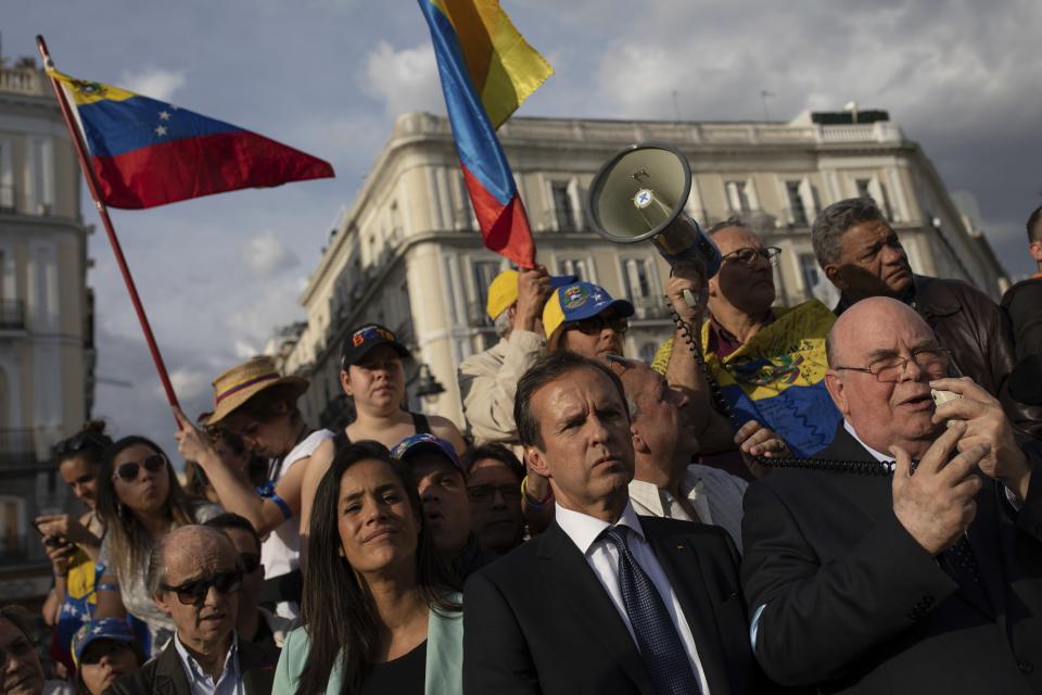 Former Bolivian President Jorge Tuto Quiroga, center, attends a meeting with supporters of Venezuelan opposition leader Juan Guaido in Madrid, Spain, Tuesday, April 30, 2019. Thousands of Venezuelans have migrated to Spain in recent years or are seeking asylum in the country, including prominent members of the opposition and former officials who worked closely with late Venezuelan President Hugo Chavez. More than 177,000 Spaniards live in Venezuela. (AP Photo/Bernat Armangue)