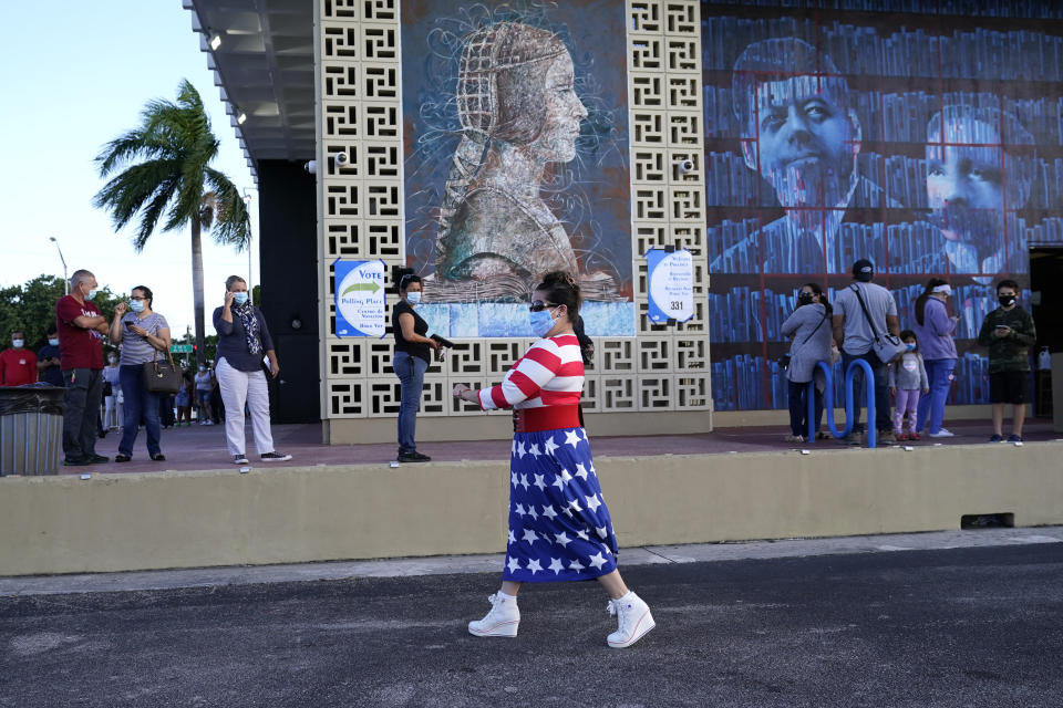 Yanitza Martinez wears red, white, and blue as she arrives to vote outside of the John F. Kennedy Library during the general election, Tuesday, Nov. 3, 2020, in Hialeah, Fla. (AP Photo/Lynne Sladky)