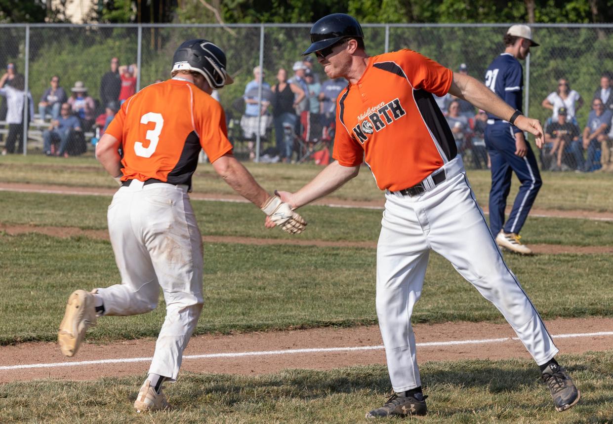 Middletown North's Dylan Briggs is congratulated by Lions' head coach Ryan McCabe after he hit a home run against Middletown South last season in a NJSIAA Central Group 3 semifinal.