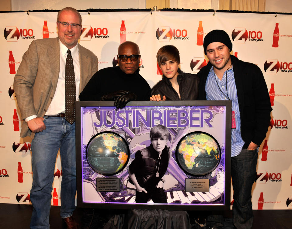 COO of Island Def Jam Music Group Steve Bartels, Island Def Jam Chairman L.A. Reid, Justin Bieber, and Scooter Braun with plaque for sales of more than 9 million worldwide for Bieber's debut album. (Kevin Mazur/WireImage)