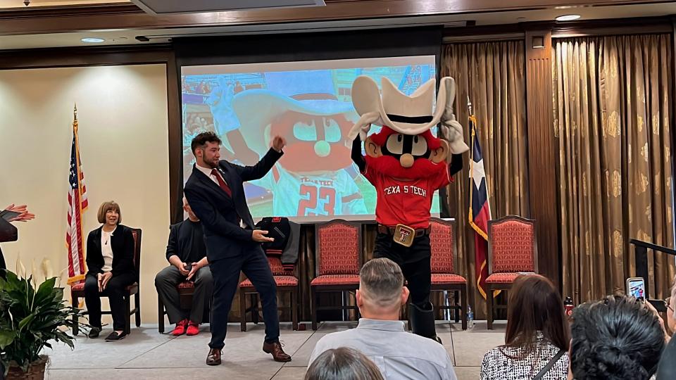 Former Raider Red Holden Jackola passing the guns to the new Raider Red, whose identity will be kept a secret, at the Passing of the Guns Ceremony at the McKenzie-Merket Alumni Center on April 19, 2024.