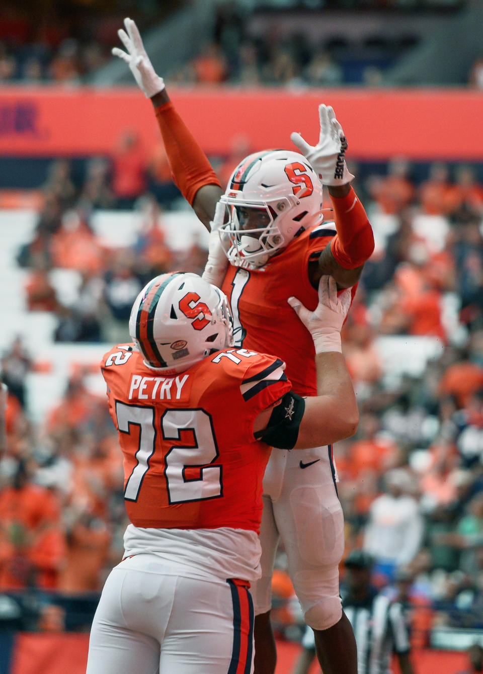 Syracuse running back LeQuint Allen Jr., top, celebrates with offensive lineman Mark Petry (72) after scoring during the first half of an NCAA college football game against Western Michigan in Syracuse, N.Y., Saturday, Sept. 9, 2023. (AP Photo/Adrian Kraus)