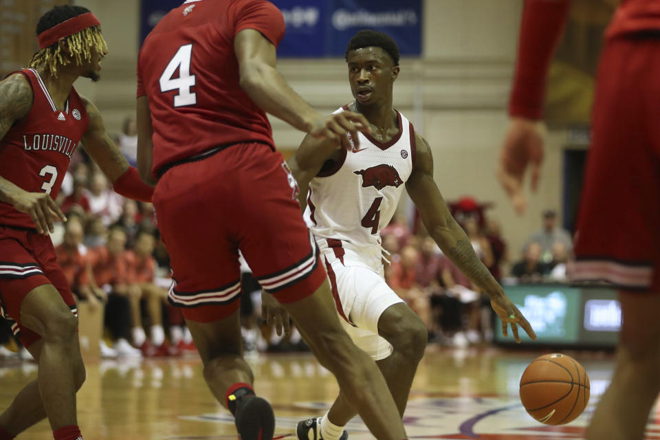 Arkansas guard Davonte Davis (4) looks for an open teammate during the first half of an NCAA college basketball game against Louisville, Monday, Nov. 21, 2022, in Lahaina, Hawaii. (AP Photo/Marco Garcia)