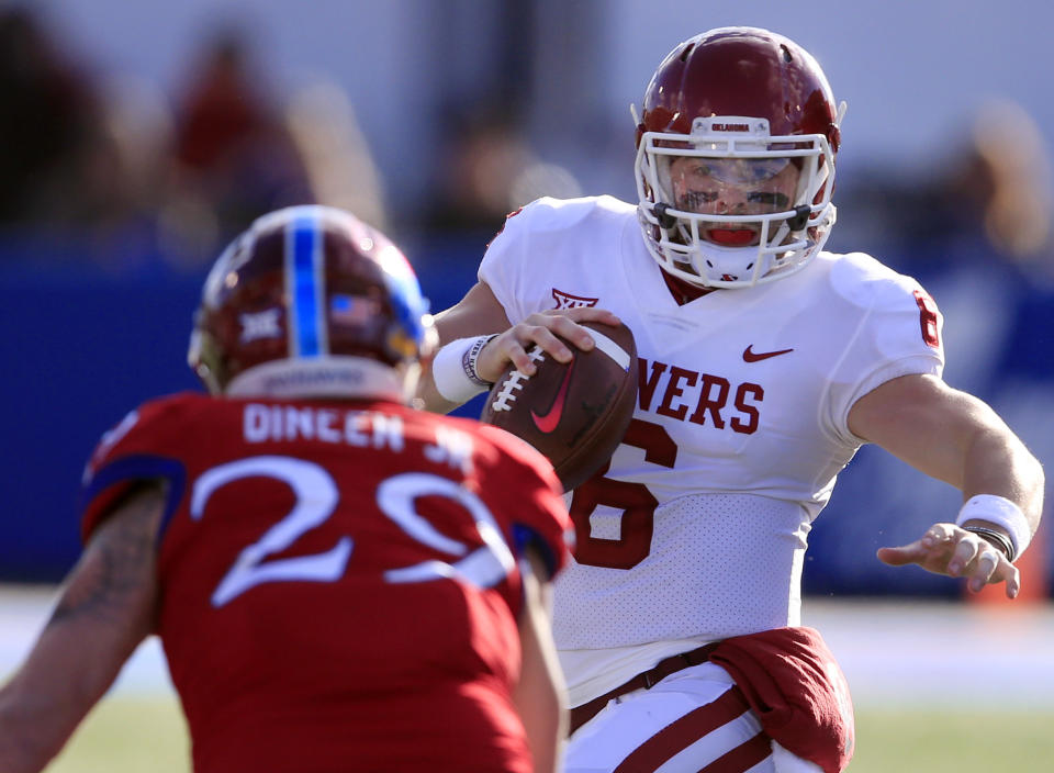 Oklahoma quarterback Baker Mayfield (6) tries to avoid Kansas linebacker Joe Dineen Jr. (29) during the first half of an NCAA college football game in Lawrence, Kan., Saturday, Nov. 18, 2017. (AP Photo/Orlin Wagner)