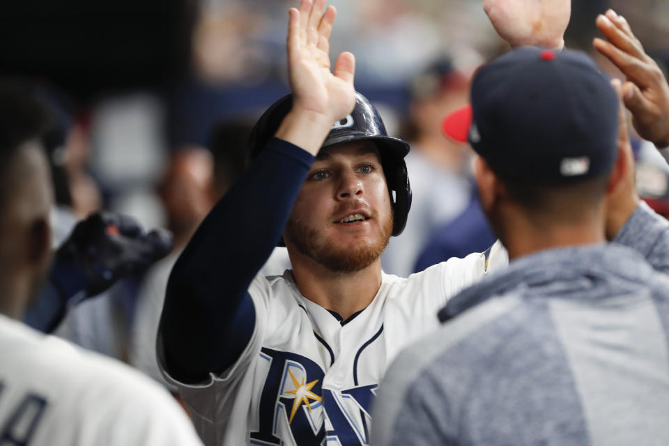 Tampa Bay Rays' Michael Brosseau celebrates in the dugout after scoring against the New York Yankees during the second inning of a baseball game Saturday, July 6, 2019, in St. Petersburg, Fla. (AP Photo/Scott Audette)