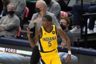 Indiana Pacers guard Edmond Sumner celebrates sinking a 3-point basket during the first half of the team's NBA basketball game against the Dallas Mavericks in Dallas, Friday, March 26, 2021. (AP Photo/Tony Gutierrez)