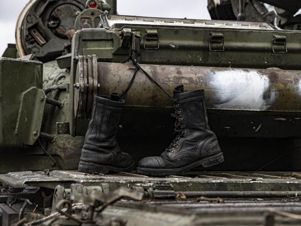 A damaged Russian military vehicle and military boots are seen after Russian Forces withdrawal as Russia-Ukraine war continues in Izium, Kharkiv Oblast, Ukraine on September 14, 2022.