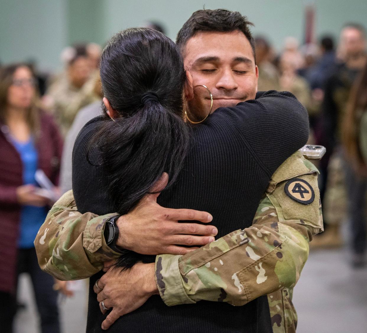 Sgt. Hennessy Lebron hugs his aunt Frances Salinas of Worcester after a sendoff ceremony for the 181st Infantry Regiment Tuesday at the DCU Center.