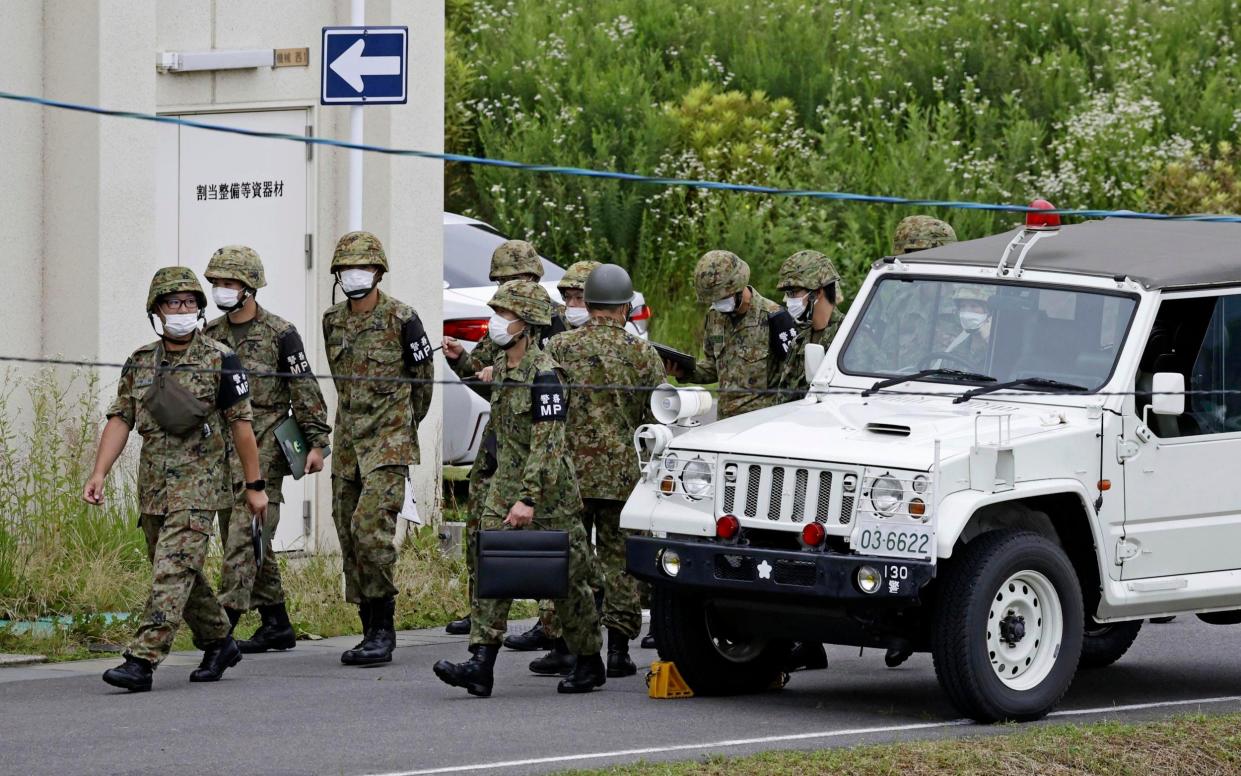 Members of Japan's self-defence force in Gifu in the aftermath of a shooting during a military exercise - Kyodo News