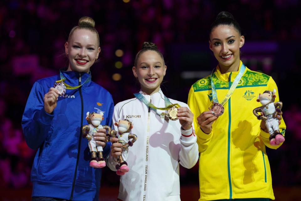 Marfa Ekimova, centre, celebrates with her gold medal (Peter Byrne/PA) (PA Wire)