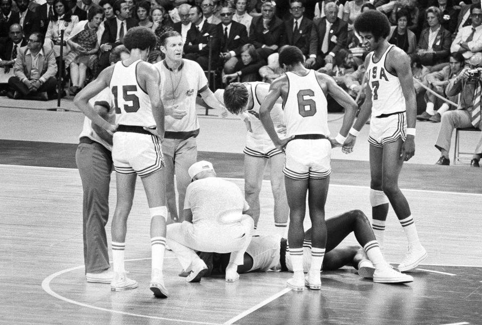 FILE - U.S. player James Brewer is checked after a hard fall during the team's men's basketball final against the Soviet Union at the Olympics in Munich, Sept. 10, 1972. Russia won 51-50. Members of the 1972 U.S. Olympic men's basketball team have talked about finally retrieving those silver medals they vowed to never accept and left behind in Germany. No, they still don't want them for themselves. They believe the medals belong in the Naismith Memorial Basketball Hall of Fame, but the latest attempt to get them from the International Olympic Committee has been thwarted. (AP Photo, File)