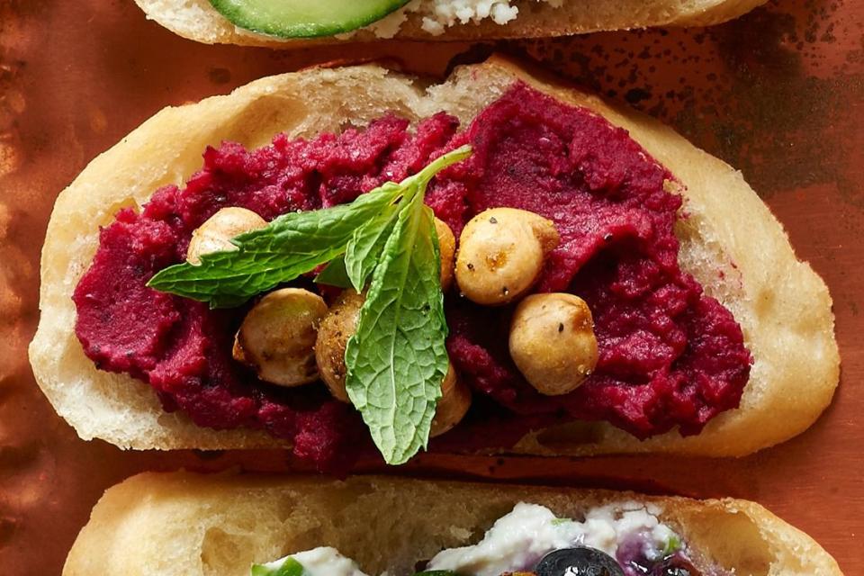 <p>This beet-infused hummus is rich with mint, cumin, and garlic. It's great topped on crostini, but just as good as a dip for carrots—or as a sandwich spread.</p><p><strong><a href="https://www.countryliving.com/food-drinks/recipes/a36517/beet-hummus-and-chickpea-crostini/" rel="nofollow noopener" target="_blank" data-ylk="slk:Get the recipe;elm:context_link;itc:0;sec:content-canvas" class="link ">Get the recipe</a>.</strong></p><p><strong><a class="link " href="https://www.amazon.com/Hamilton-Beach-70730-Processor-Vegetable/dp/B008J8MJIQ/?tag=syn-yahoo-20&ascsubtag=%5Bartid%7C10050.g.34063059%5Bsrc%7Cyahoo-us" rel="nofollow noopener" target="_blank" data-ylk="slk:SHOP FOOD PROCESSORS;elm:context_link;itc:0;sec:content-canvas">SHOP FOOD PROCESSORS</a></strong></p>