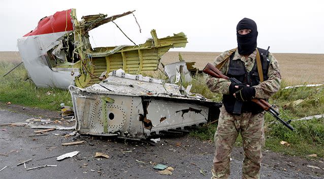 An armed pro-Russian separatist stands at a site of a Malaysia Airlines Boeing 777 plane crash in the settlement of Grabovo in the Donetsk region, Ukraine July 17, 2014. Photo: REUTERS/Maxim Zmeyev.