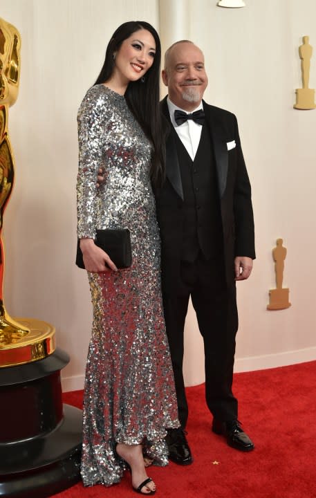 Clara Wong, left, and Paul Giamatti arrive at the Oscars on Sunday, March 10, 2024, at the Dolby Theatre in Los Angeles. (Photo by Richard Shotwell/Invision/AP)