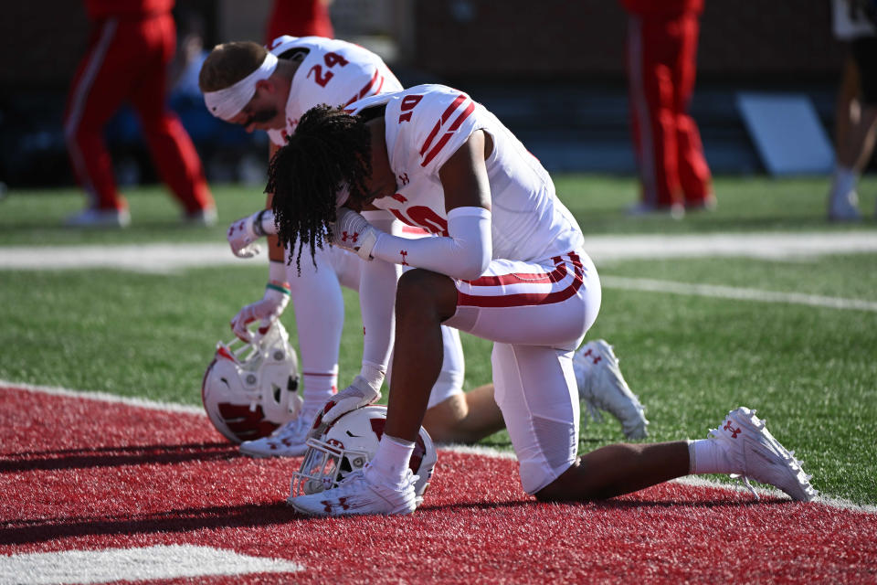 Sept. 9, 2023; Pullman, Washington; Wisconsin Badgers cornerback Nyzier Fourqurean (10 and Wisconsin Badgers safety Hunter Wohler (24) pray before their game against the Washington State Cougars at Gesa Field at Martin Stadium. James Snook-USA TODAY Sports