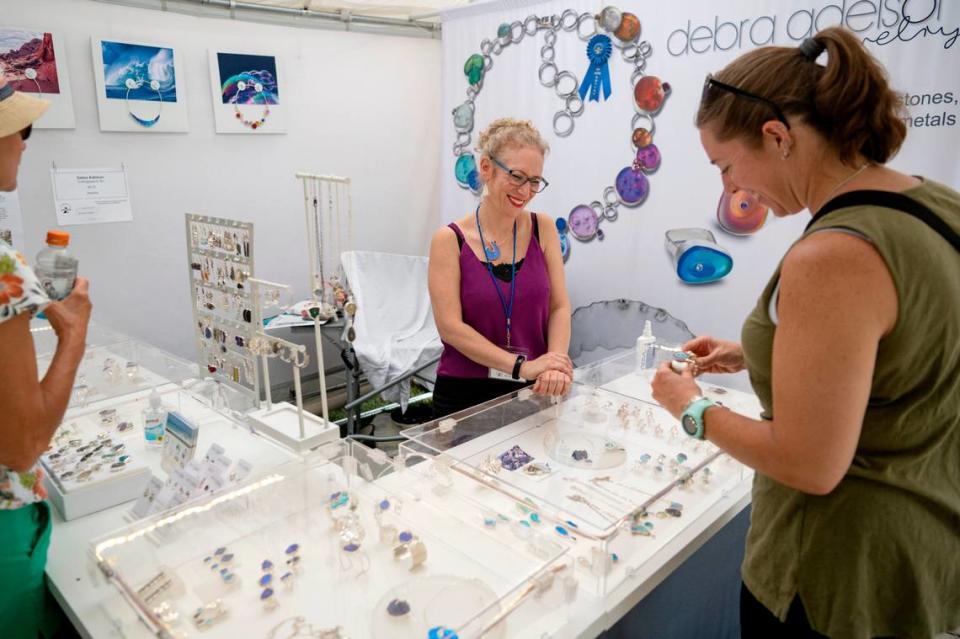 Debra Adelson talks about her jewelry with Erin Thomas at the Central Pennsylvania Festival of the Arts on Thursday, July 14, 2022.  