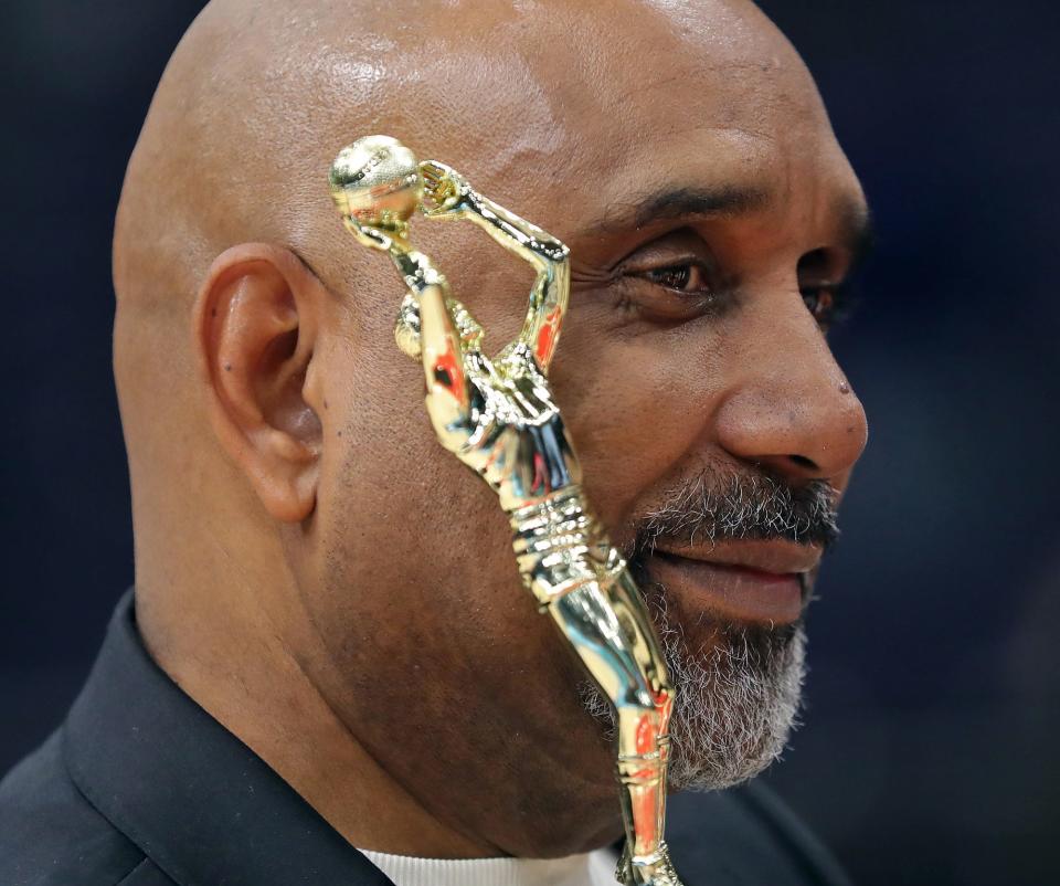St. Vincent-St. Mary basketball coach Dru Joyce II holds the Division II state championship trophy after a 63-35 win over Gilmour Academy at the University of Dayton Arena on Sunday. [Jeff Lange/Beacon Journal]
