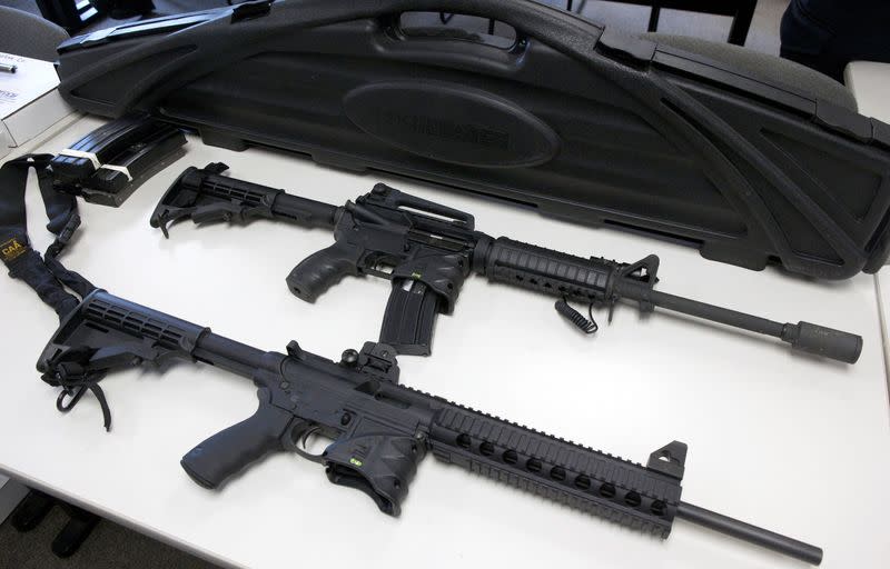 FILE PHOTO: A Bushmaster semi-automatic assault rifle and a Smith & Wesson semi-automatic rifle are turned in during a gun buyback event in New Haven