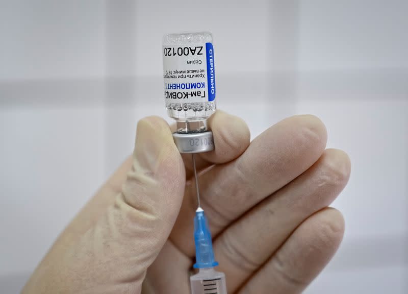 FILE PHOTO: A medical worker fills a syringe with Sputnik V (Gam-COVID-Vac) vaccine as she prepares to vaccinate a Russian Army service member at a clinic in the city of Rostov-On-Don