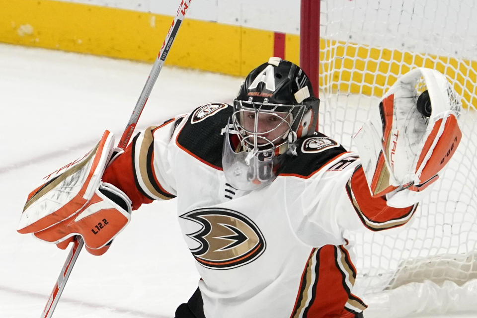 Anaheim Ducks goaltender John Gibson makes a glove save during the second period of an NHL hockey game against the Colorado Avalanche Wednesday, Jan. 19, 2022, in Anaheim, Calif. (AP Photo/Mark J. Terrill)