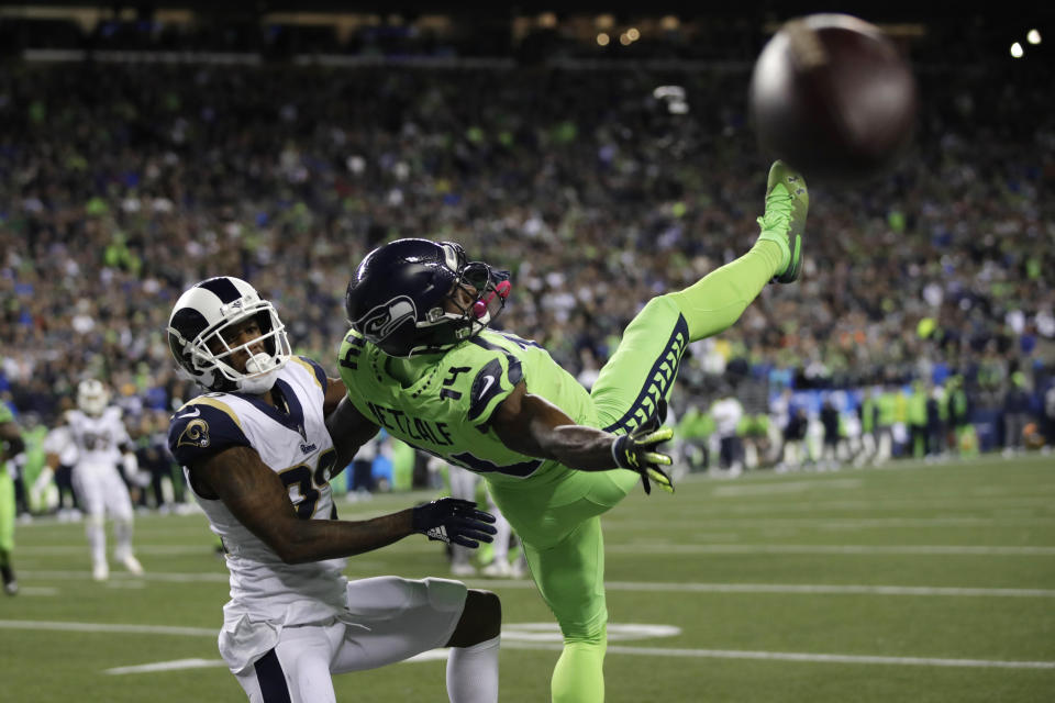 Seattle Seahawks wide receiver DK Metcalf, right, goes down next to Los Angeles Rams cornerback Marcus Peters as a pass for a 2-point conversion falls incomplete during the second half of an NFL football game Thursday, Oct. 3, 2019, in Seattle. (AP Photo/Stephen Brashear)