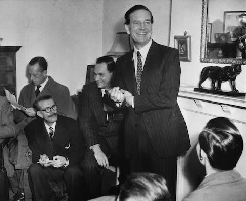 Kim Philby jokes with journalists at his mother's London home during a 1955 press conference - Credit: Bettmann