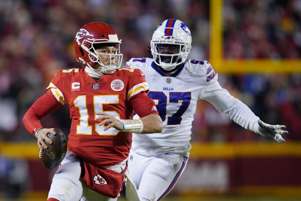 Kansas City Chiefs quarterback Patrick Mahomes (15) is pressured by Buffalo Bills defensive end Mario Addison (97) during the second half of an NFL divisional round playoff football game, Sunday, Jan. 23, 2022, in Kansas City, Mo. (AP Photo/Ed Zurga)