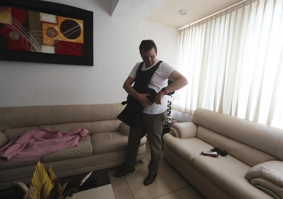 A man puts on a bulletproof vest