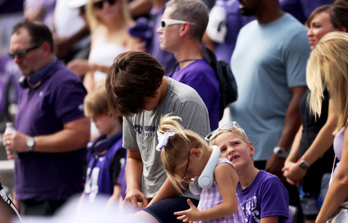 TCU fans bow their heads for a moment of silence for Wes Smith at the start of the team’s season opener on Saturday. Smith, a TCU student, was fatally shot in the West 7th district on Friday.