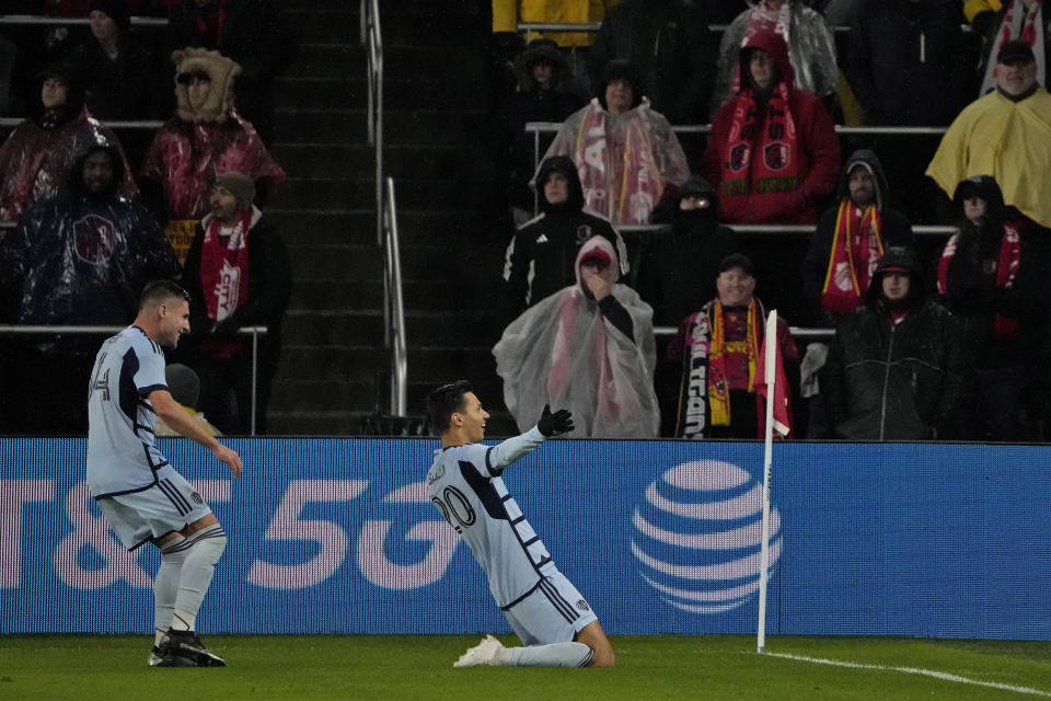 Sporting Kansas City forward Dániel Sallói (20) celebrates with Sporting Kansas City midfielder Rémi Walter, left, after scoring a goal during the second half of an MLS playoff soccer match against St. Louis City Sunday, Oct. 29, 2023, in St. Louis. (AP Photo/Jeff Roberson)