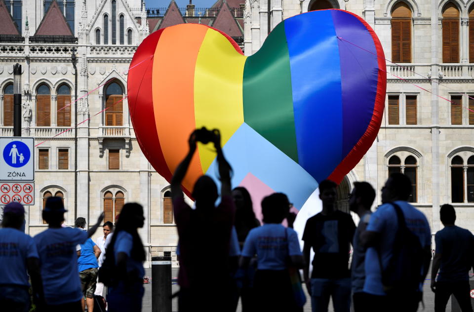 People gather in front of a huge rainbow balloon put up by members of Amnesty International and Hatter, an NGO promoting LGBT rights, at Hungary's parliament in Budapest, Hungary, July 8, 2021. REUTERS/Marton Monus