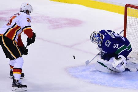 Feb 9, 2019; Vancouver, British Columbia, CAN; Vancouver Canucks goaltender Jacob Markstrom (25) blocks a shot by Calgary Flames forward Sean Monahan (23) during the shootout at Rogers Arena. Mandatory Credit: Anne-Marie Sorvin-USA TODAY Sports