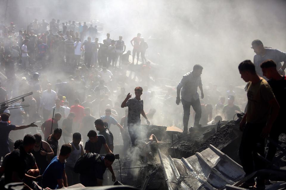 Palestinians inspect the rubble of destroyed buildings following Israeli airstrikes on the town of Khan Younis, southern Gaza Strip, Thursday, Oct. 26, 2023.