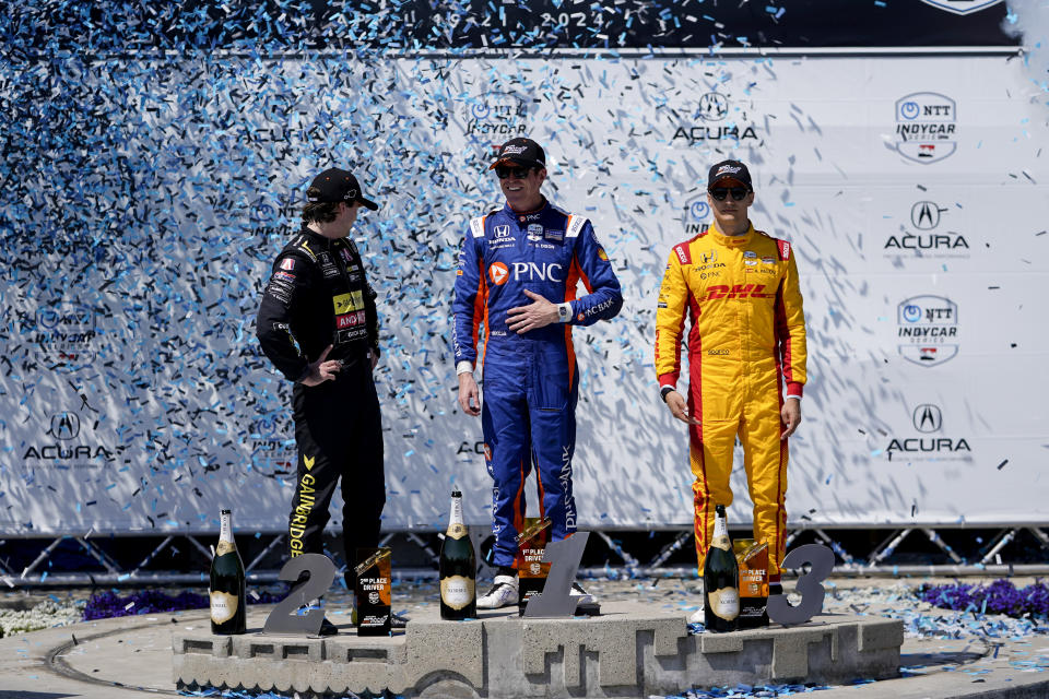 Chip Ganassi Racing driver Scott Dixon, center, celebrates his first place victory during the IndyCar Grand Prix of Long Beach auto race Sunday, April 21, 2024, in Long Beach, Calif. Andretti Global with Curb-Agajanian driver Colton Herta, left, won second, and Chip Ganassi Racing driver Álex Palou won third. (AP Photo/Ryan Sun)