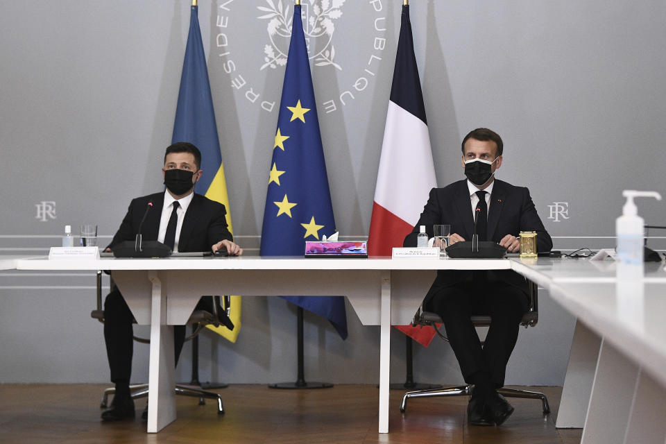 French President Emmanuel Macron, right, and Ukrainian President Volodymyr Zelenskyy hold a press conference following their meeting at the Elysee Palace in Paris Friday April 16, 2021. Ukrainian President Volodymyr Zelenskyy is in Paris for talks with French President Emmanuel Macron and German Chancellor Angela Merkel amid his country's growing tensions with neighboring Russia, which has deployed troops near its border with Ukraine. (Anne-Christine Poujoulat, Pool via AP)